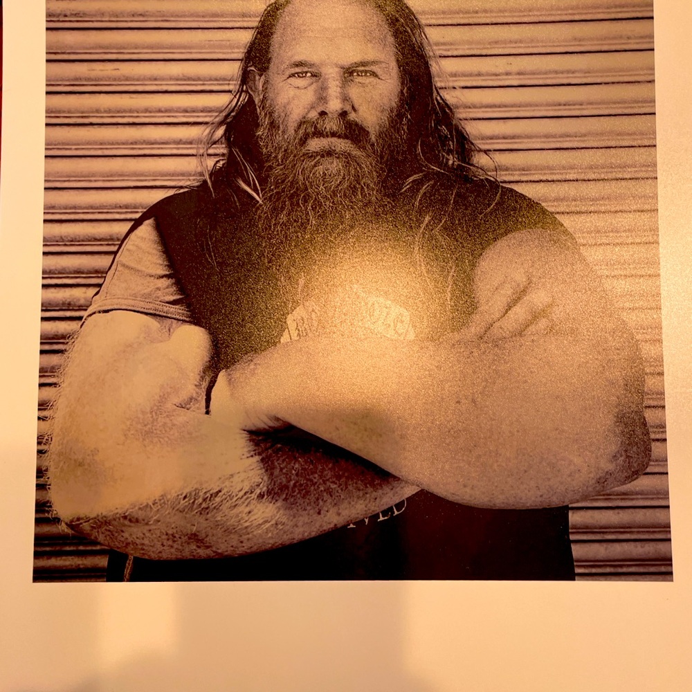 Photo of Hell’s Angel with arms crossed in B/W